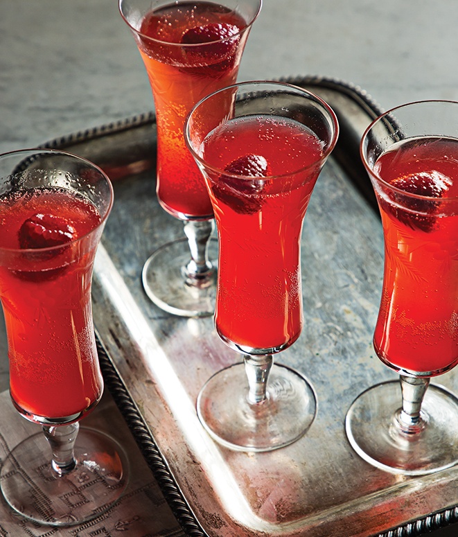 raspberry-infused Champagne in flutes topped with fresh raspberry